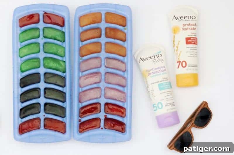 Vibrant colored ice cubes, made with drink mix, are ready for outdoor baby sensory play, offering a cool and engaging activity for toddlers and infants.