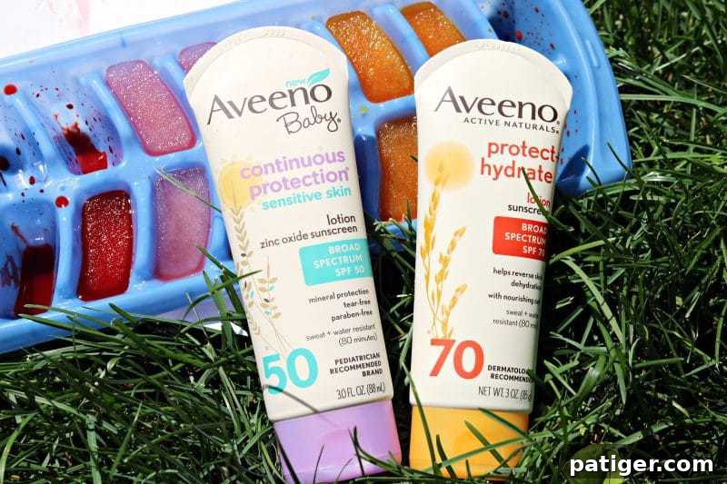 A baby delightedly explores a vibrant assortment of colored ice cubes on a white poster board, enjoying a refreshing outdoor sensory activity during summer.