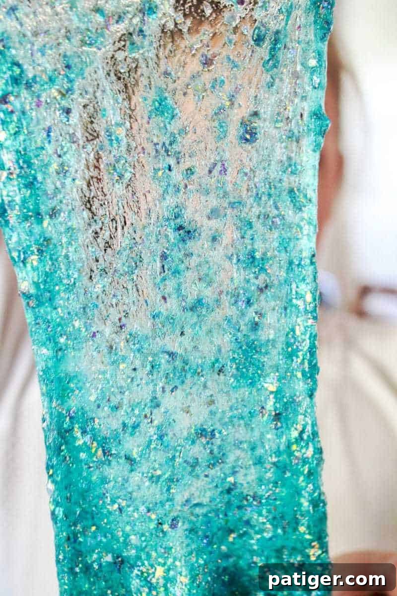 Beautiful close-up of vibrant teal borax-free mermaid slime with glitter.