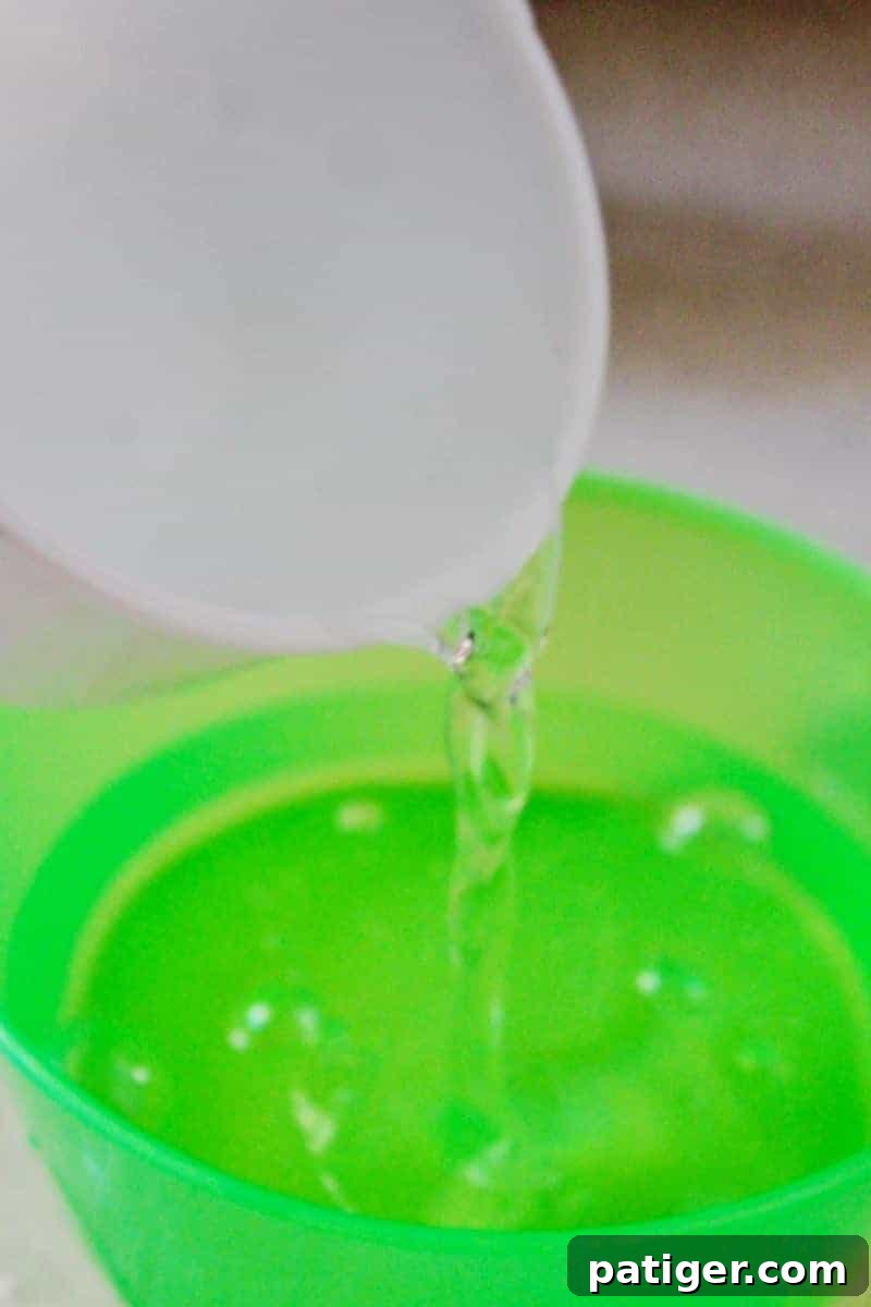 Step 1: Adding water and glue to a bowl for borax-free mermaid slime.