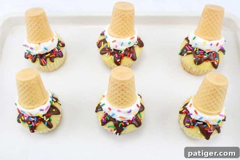 Drippy Delight Cone Cupcakes 8 Fourth step showing a scoop of white frosting added to a cupcake, resembling a scoop of ice cream on top of the chocolate drip