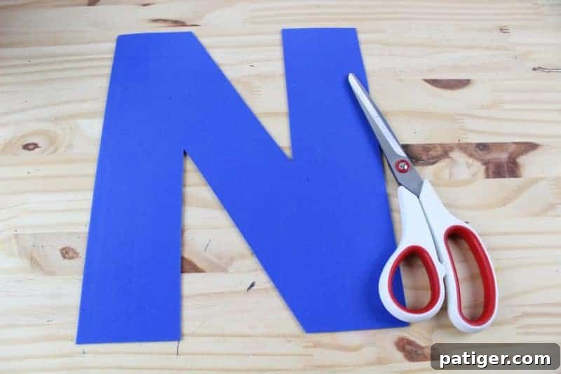 Nifty Nests Printable Letter N Craft 5 Step 3 in the Letter N craft: Cutting out the traced letter N from the craft foam or cardstock, further developing fine motor skills and preparing the base for the nest attachment.