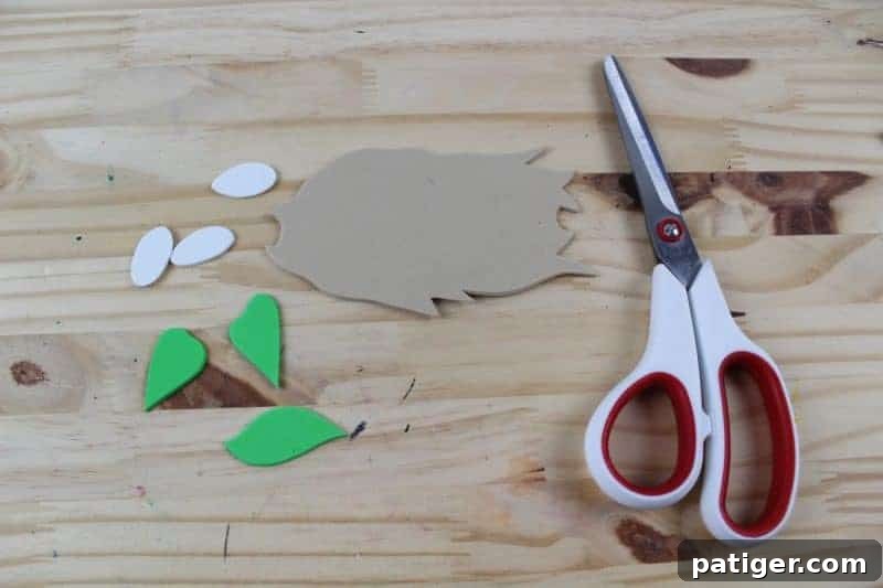 Nifty Nests Printable Letter N Craft 6 Step 4 of the Letter N craft: Tracing and cutting out the nest, egg, and leaf shapes from the nest printable template onto craft foam, creating the decorative elements.