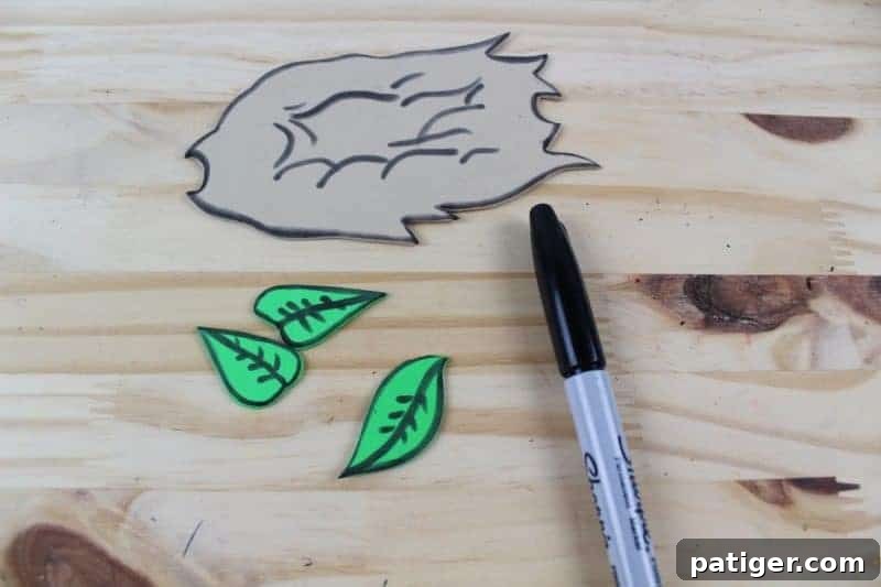 Nifty Nests Printable Letter N Craft 7 Step 5 in the Letter N craft: Using a black marker to add outlines and textural details to the cut-out nest shape, enhancing its appearance and making it more realistic.