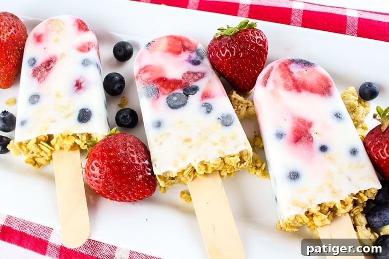 These easy yogurt popsicles are packed with fresh berries and granola, making them a tasty frozen breakfast to enjoy on-the-go on busy mornings.