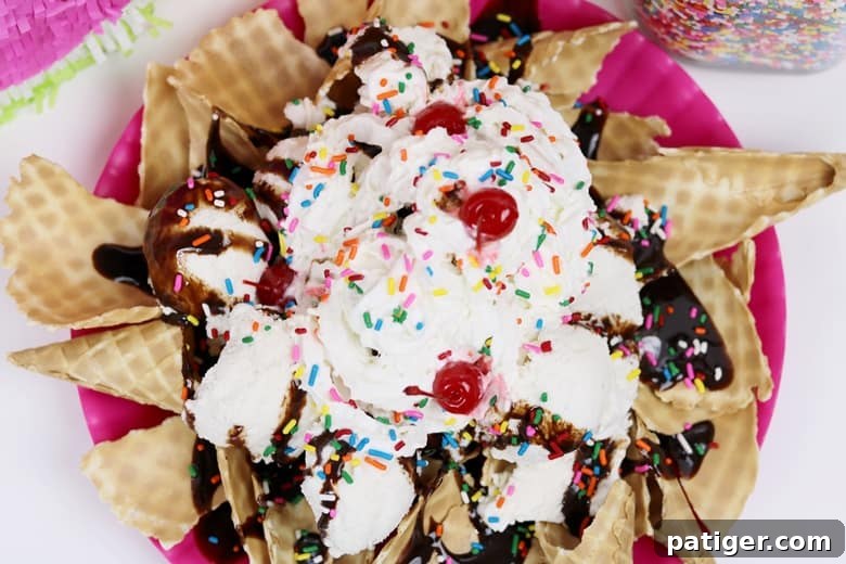 Beat the Summer Heat with This Easy Ice Cream Treat 3 A close-up shot of a magnificent ice cream nachos sundae, generously loaded with vanilla ice cream, fluffy whipped cream, colorful sprinkles, rich chocolate syrup, and bright red maraschino cherries, ready to be enjoyed.