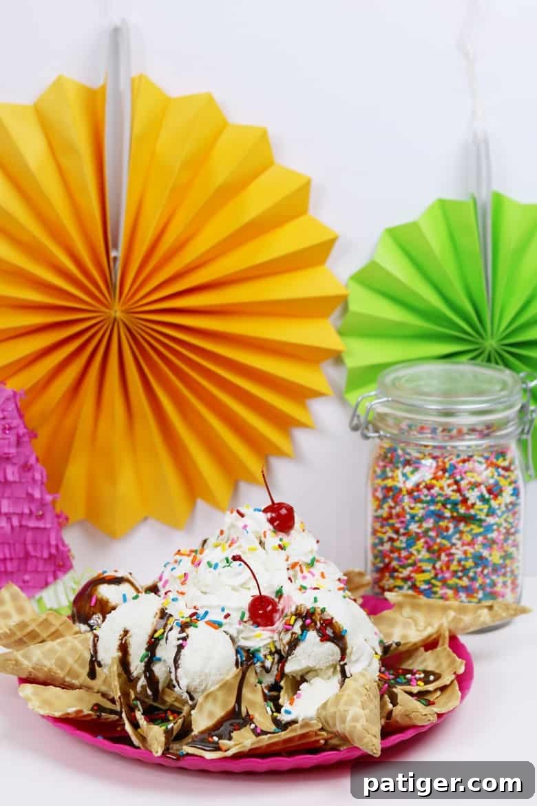 Beat the Summer Heat with This Easy Ice Cream Treat 4 A vibrant platter of ice cream nachos sundae, adorned with a variety of toppings, accompanied by a small container of rainbow sprinkles, showcasing the delightful customization possibilities.