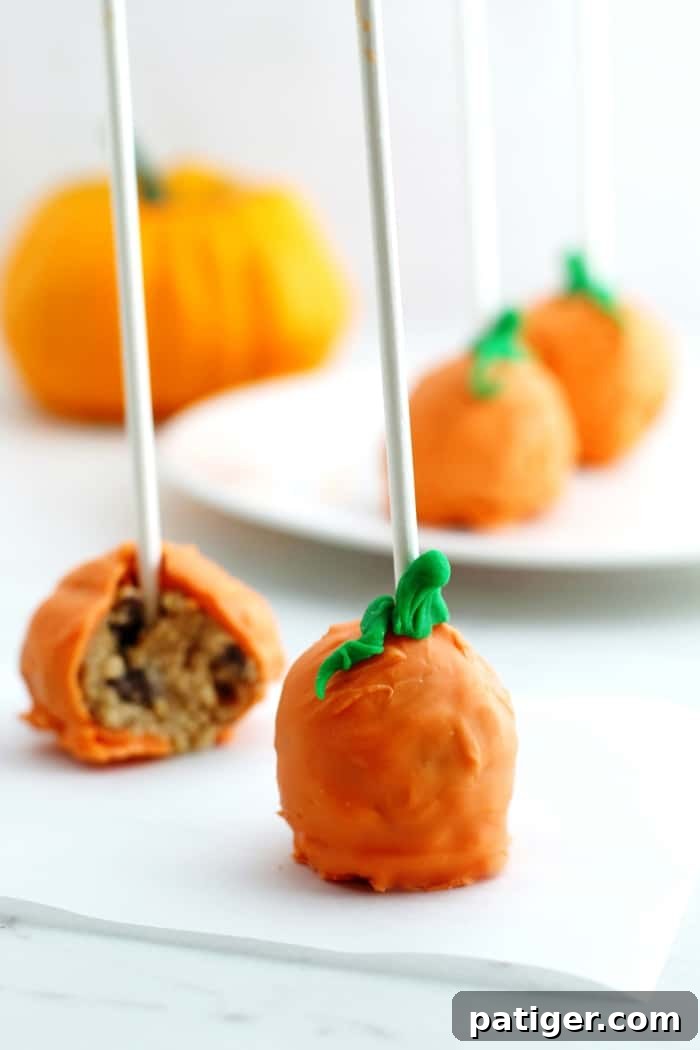 Easy to make, pumpkin-shaped cookie dough pops for Halloween parties