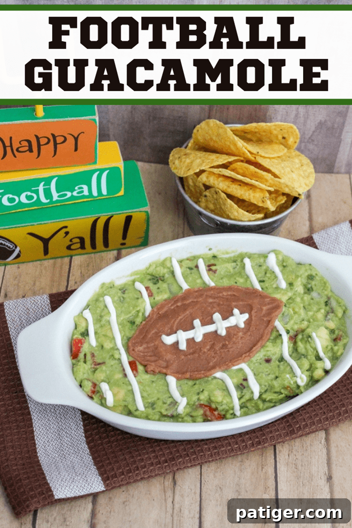 A visually appealing Pinterest-optimized image of the homemade guacamole football, complete with yard lines and refried bean football, with text overlay for easy sharing.