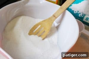 Wooden spoon stirring a bowl of the tablet mixture
