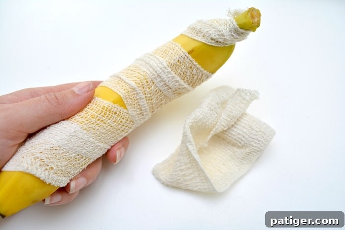 Step-by-step image showing how to wrap a banana with gauze to create a mummy Halloween snack