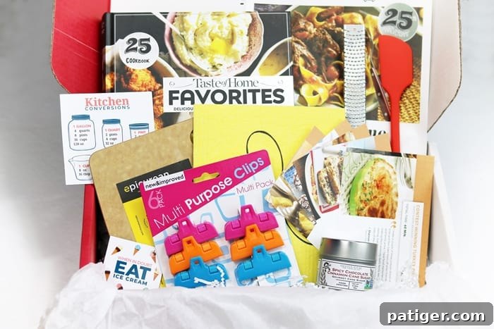 The Taste of Home Special Delivery box, brimming with a variety of carefully selected kitchen essentials and gourmet ingredients, showcasing its value for home cooks. Items like spices, a cutting board, and a cookbook are visible, hinting at the treasures within this quarterly subscription box designed for all culinary skill levels.