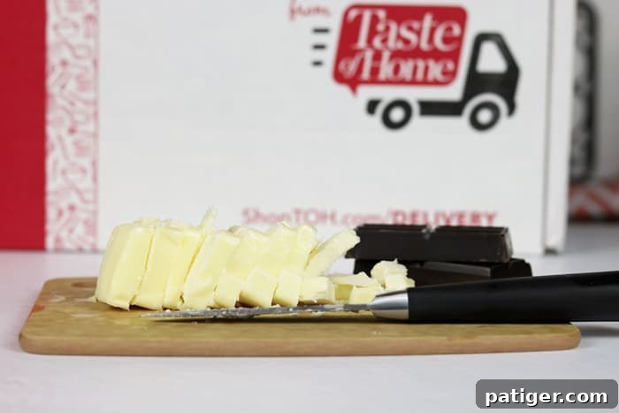 The Epicurean cutting board from the Taste of Home Special Delivery box, positioned next to ingredients for baking. This image highlights the practical utility of the kitchen gadget received in the subscription box, demonstrating its role in a home cooking project.