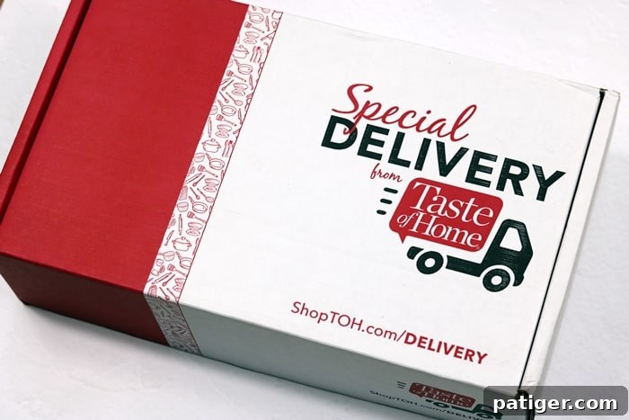 The Taste of Home Special Delivery Subscription Box, freshly unboxed, showcasing a variety of high-quality kitchen gadgets and gourmet ingredients. The image highlights the value and excitement of receiving a curated selection of culinary items, designed to inspire and assist home cooks in their kitchen adventures.