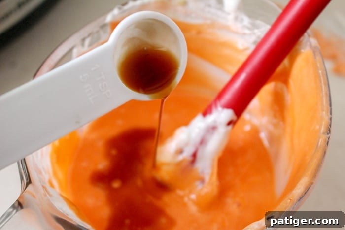 Ingredients for candy corn slime laid out: marshmallows, candy corn, vanilla, and powdered sugar