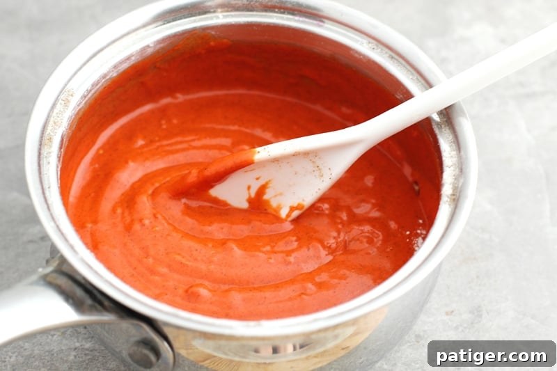 Sensory Pumpkin Spice Playdough 5 Mixing and heating pumpkin playdough ingredients on a stovetop