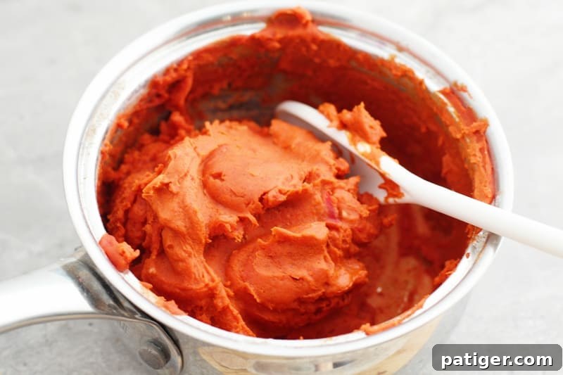 Sensory Pumpkin Spice Playdough 6 Pumpkin playdough mixture thickening on the stovetop