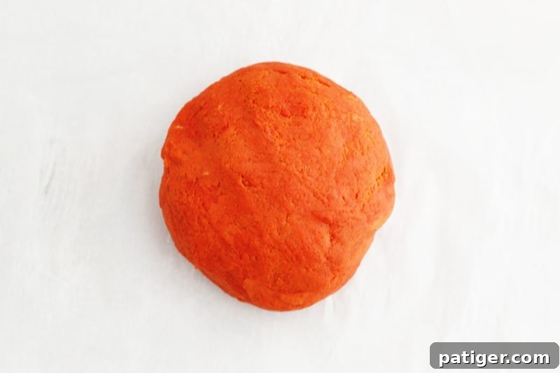 Sensory Pumpkin Spice Playdough 7 Kneading cooled pumpkin playdough until smooth and evenly colored