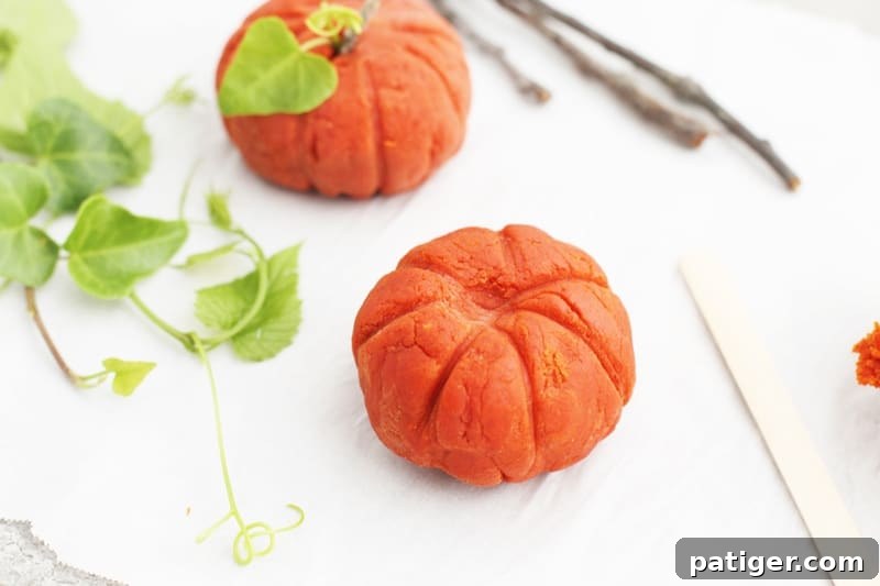 Sensory Pumpkin Spice Playdough 8 Child playing with taste-safe pumpkin spice playdough, enjoying sensory exploration