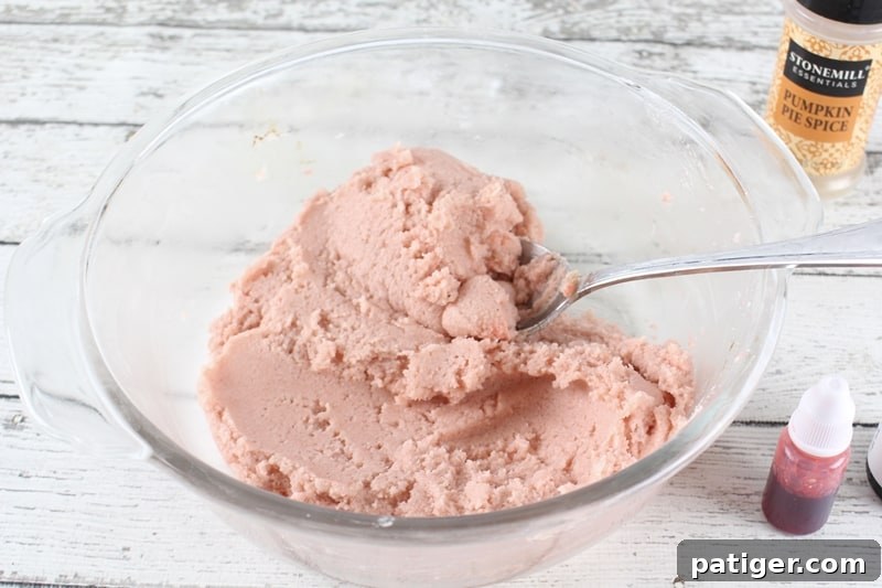 The process of making pumpkin spice bath bombs, showing the mixed ingredients and the shaping process.