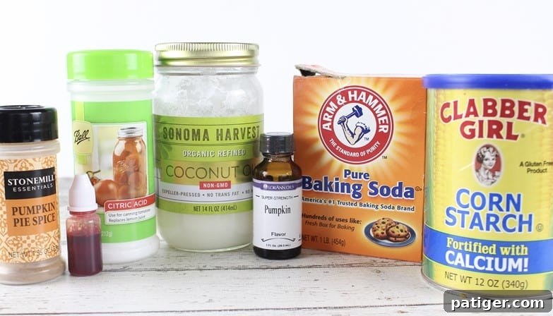 A collection of ingredients for making pumpkin spice bath bombs, including baking soda, citric acid, corn starch, coconut oil, and pumpkin pie spice.