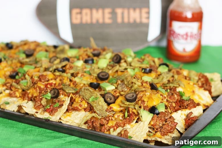 An easy loaded nachos recipe made in the oven. These baked nachos are packed with savory ground beef, gooey cheddar cheese, and FRENCH'S™ Crispy Jalapeños for extra crunch and flavor.