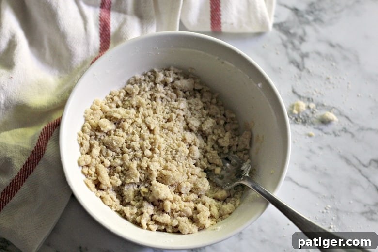 A close-up of the prepared crumb topping for an apple danish, showing its perfect crumbly texture.