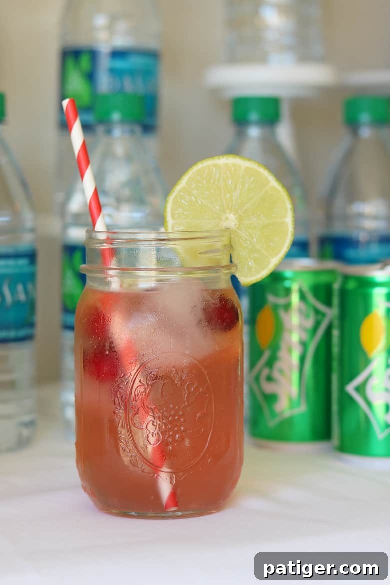 Level Up Your Party with a Custom Soda Bar 6 A refreshing cherry limeade made with Sprite, garnished with fresh lime, showcasing the customizable options.