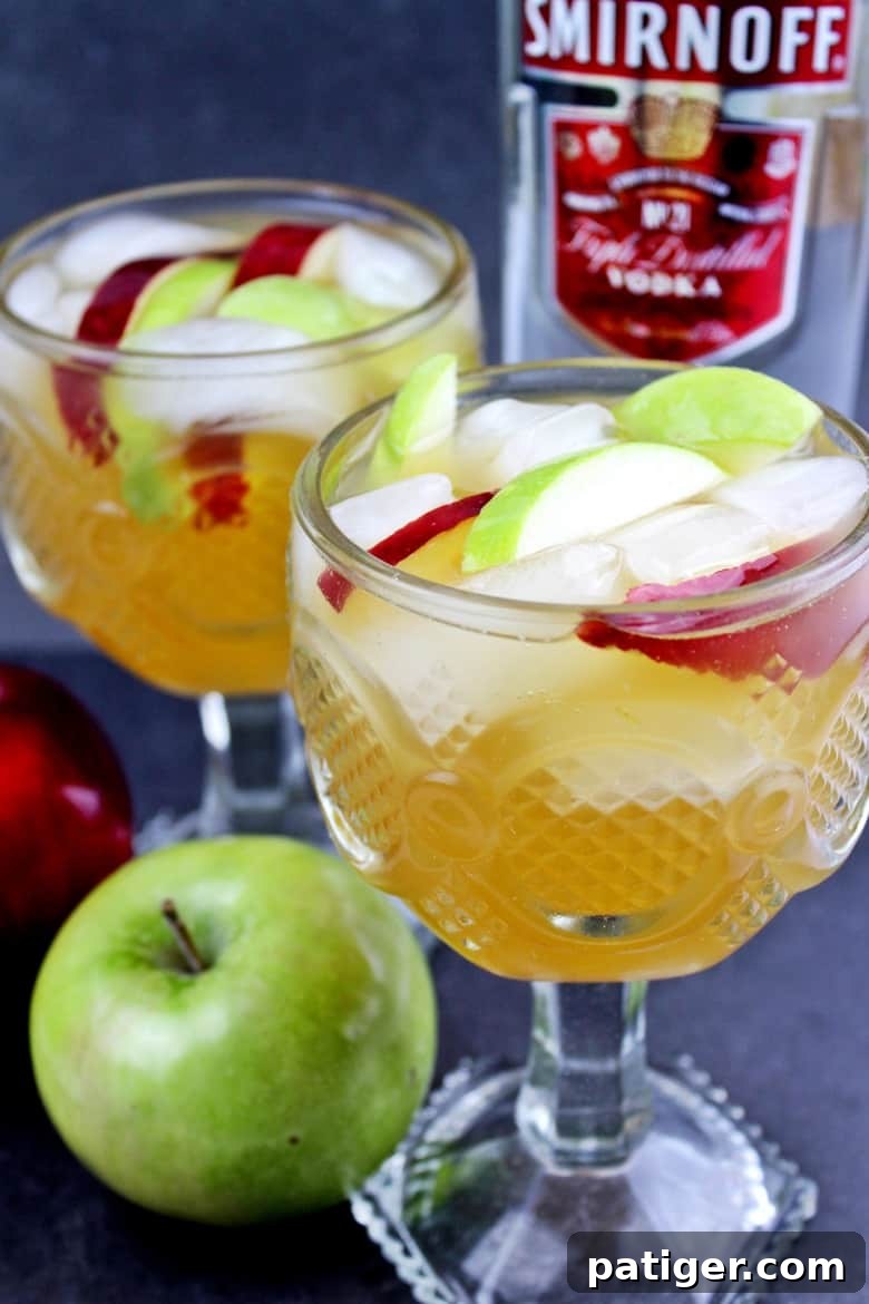 Easy apple cider sangria recipe made with white wine, apple cider, Sprite, vodka, and apples. This festive and refreshing apple cocktail is perfect for serving up at your holiday parties.