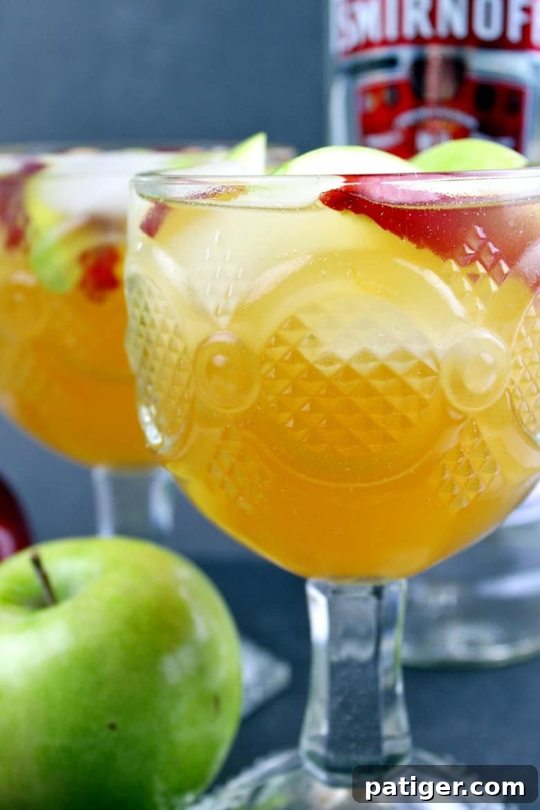 Easy apple cider sangria recipe made with white wine, apple cider, Sprite, vodka, and apples. This festive and refreshing apple cocktail is perfect for serving up at your holiday parties.