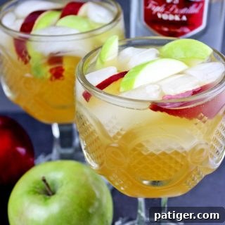 Easy apple cider sangria recipe made with white wine, apple cider, Sprite, vodka, and apples. This festive and refreshing apple cocktail is perfect for serving up at your holiday parties.