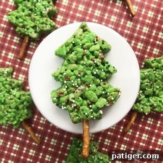 Vibrant green Christmas Tree Rice Krispie Treats decorated with festive sprinkles, perfect for a holiday dessert table.