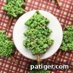 Vibrant green Christmas Tree Rice Krispie Treats decorated with festive sprinkles, perfect for a holiday dessert table.