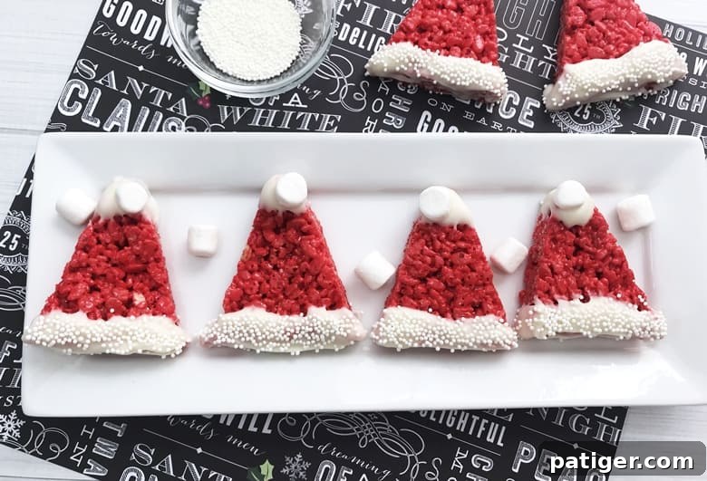 Santa Hat Rice Krispie Treats are easy to make for the kids this Christmas using a traditional Rice Krispies Treat recipe and just adding a few decorations!