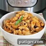 Cheesy Hamburger Casserole in a white bowl in front of an Instant Pot