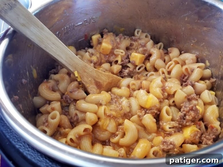 Cheeseburger Casserole bubbling hot inside the Instant Pot after pressure cooking.