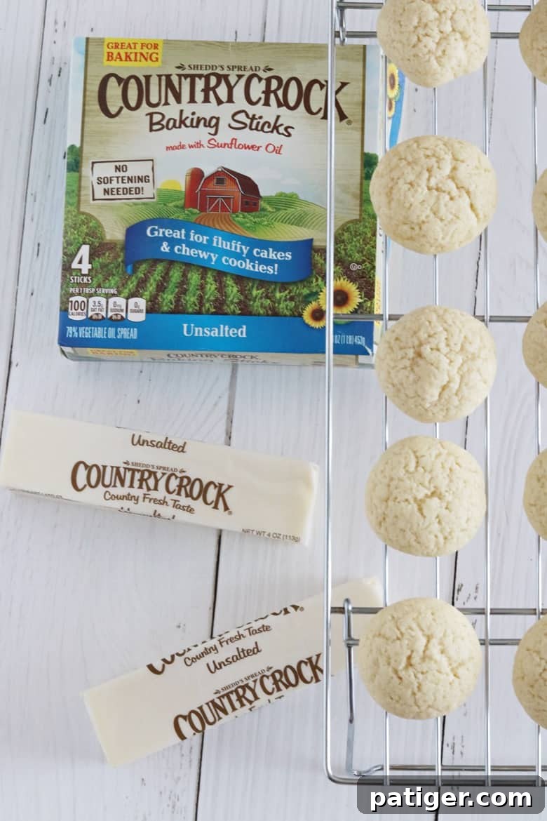 Italian Christmas cookies cooling on baking rack with Country Crock Baking Sticks in the background