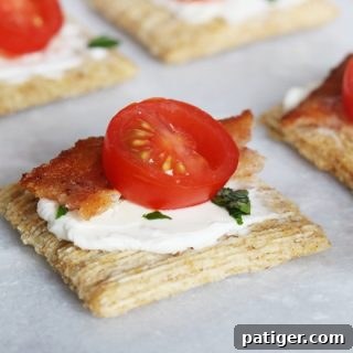 Festive Triscuit Bites 7 Triscuit crackers with cream cheese, bacon, and tomato on a platter