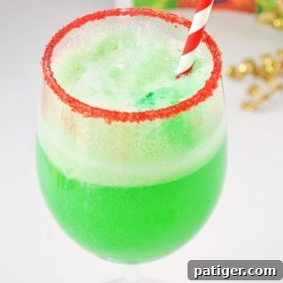 This small-batch Grinch Punch recipe made with Hawaiian Punch, Sprite, and lime sherbet is a perfect drink for the kids on Christmas.