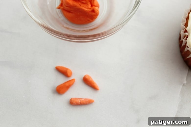 using orange fondant to form the shape of carrot noses