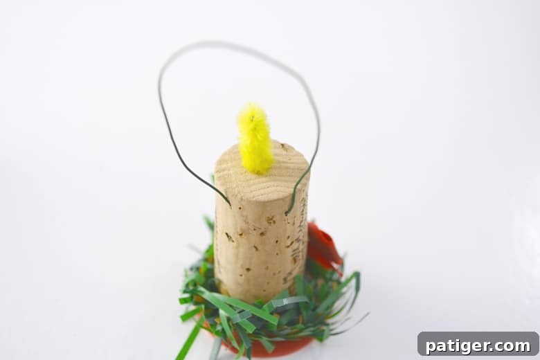 Handmade Wine Cork Candle Ornaments 8 The backside of a finished wine cork candle ornament, clearly showing the securely attached floral wire loop functioning as its hanger.