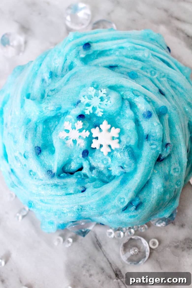 An easy Frozen slime recipe that Elsa would approve of! This glittery snowflake slime makes for a great Winter sensory play activity.