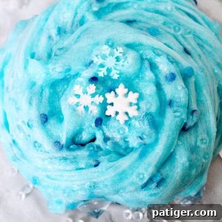 An easy Frozen slime recipe that Elsa would approve of! This glittery snowflake slime makes for a great Winter sensory play activity.