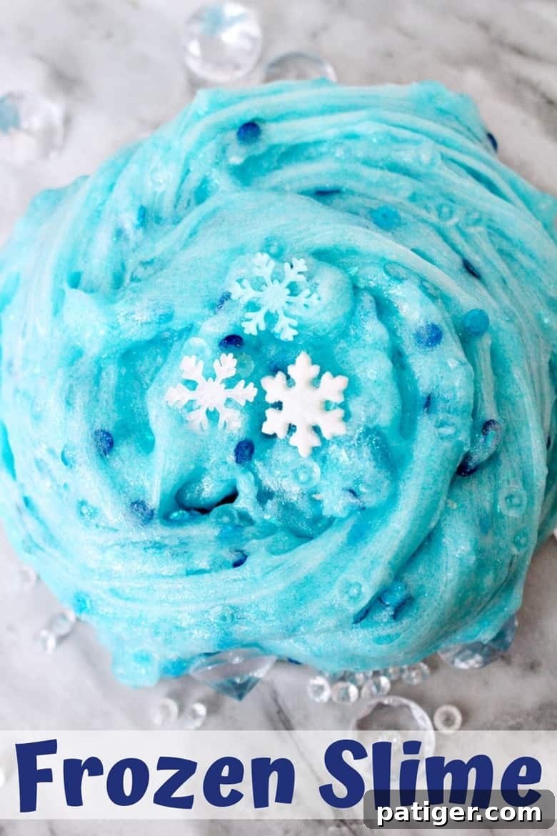 An easy Frozen slime recipe that Elsa would approve of! This glittery snowflake slime makes for a great Winter sensory play activity. Pin it for later!