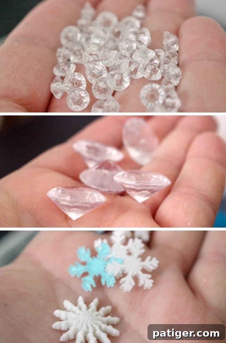 A collection of mix-ins for Elsa Frozen slime, including snowflake and diamond beads, blue sequins, and faux snow.