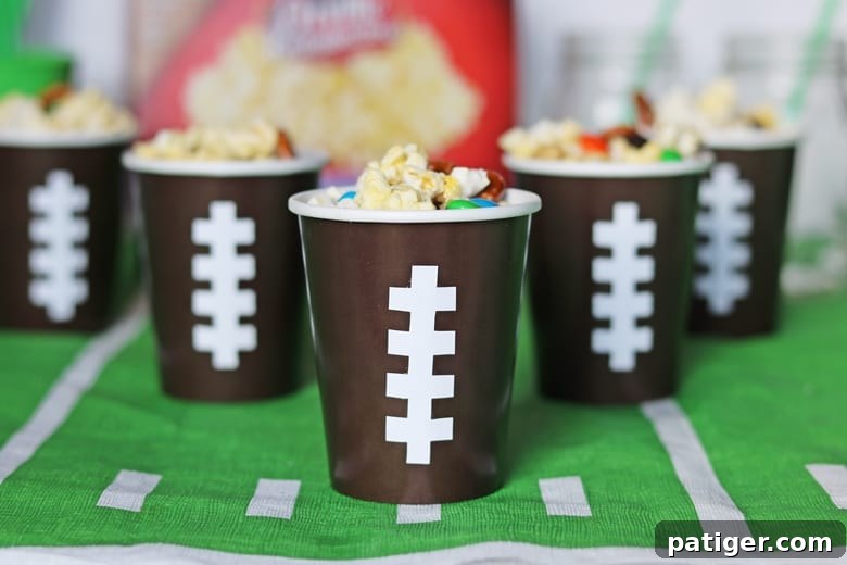 Tailgate Treat: Speedy Sweet and Salty Mix with Custom Football Holders 2 Sweet and Salty snack mix in football cups