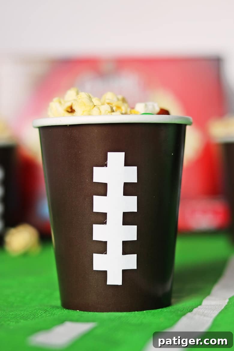 Tailgate Treat: Speedy Sweet and Salty Mix with Custom Football Holders 8 Brown paper cups with white stitching down the front, designed to look like a football
