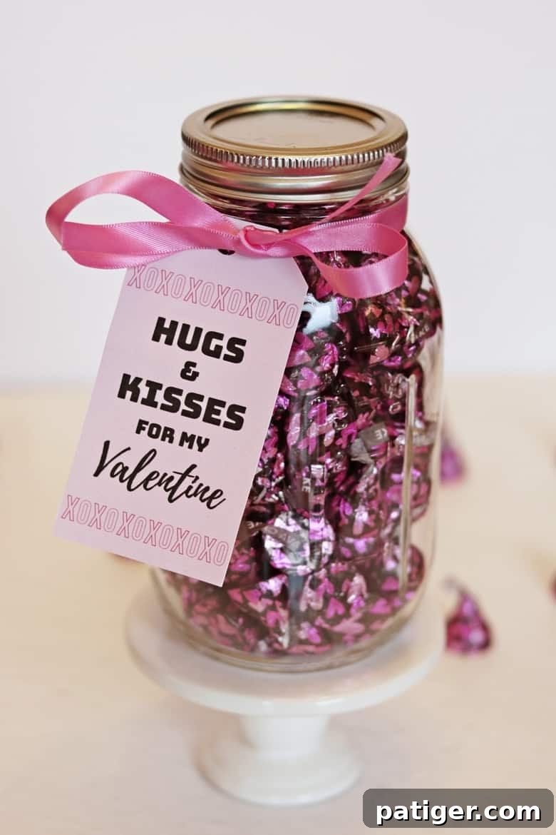 DIY Hershey Kisses Valentine gift in a mason jar with a printable tag reading "hugs and kisses for my Valentine".