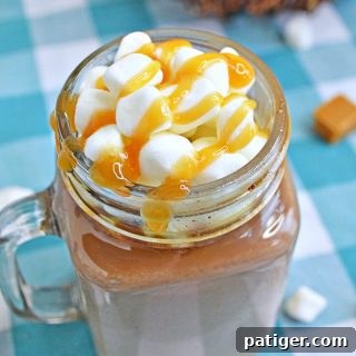 A rich and creamy salted caramel hot chocolate recipe that you can make easily right at home in your slow cooker. Topped with whipped cream and caramel drizzle.