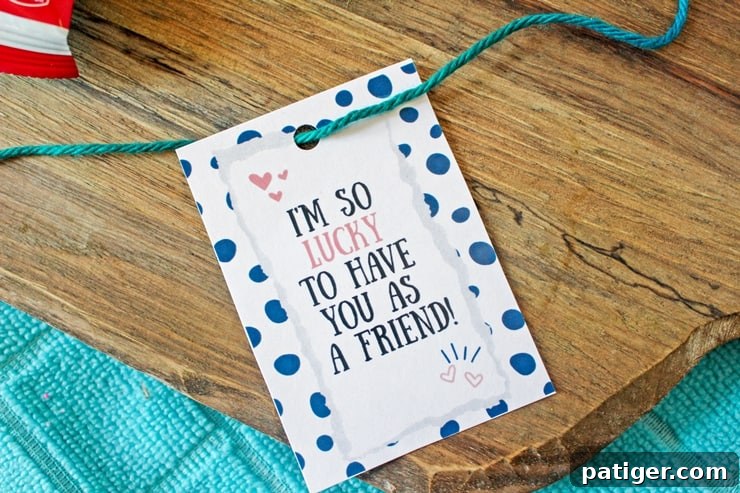 A printed gift tag with a hole punched at the top and green yarn threaded through